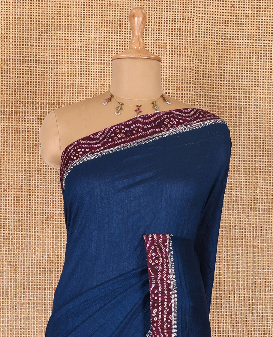 Blue plain Vichitra silk saree, contrast bandhani printed with Swarovski micro-stonework border, and a contrast bandhani printed blouse
