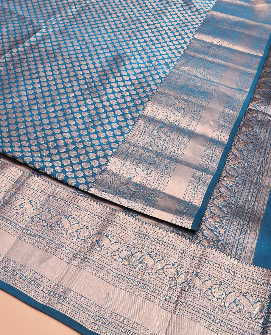 Blue Kanchipuram Wedding Silk Saree Gracefully Embellished with Zari Buttas, Highlighted with Zari Border of Thilakam, Star Vanki, Yaanai, and Round Mayil Designs, Majestically Zari-Woven Pallu, and Paired with a Matching Blouse