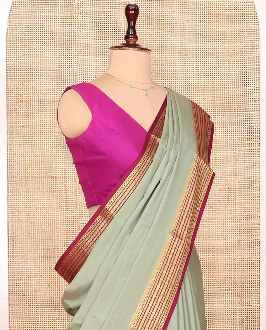 Green Plain Mysore Silk Saree Complemented by Captivating Contrast Traditional Zari Designs Woven Border, Gleaming Zari Striped Pallu and Paired with a Contrast Blouse