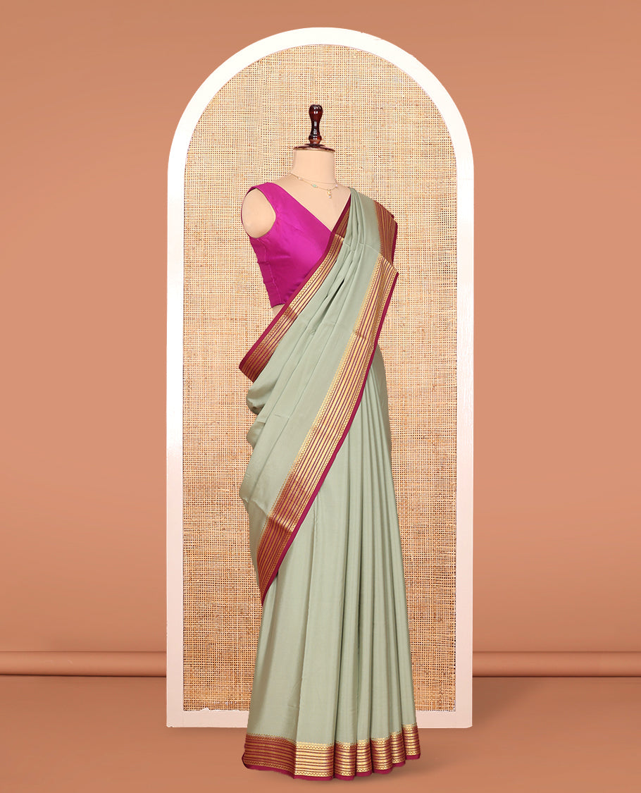 Green Plain Mysore Silk Saree Complemented by Captivating Contrast Traditional Zari Designs Woven Border, Gleaming Zari Striped Pallu and Paired with a Contrast Blouse