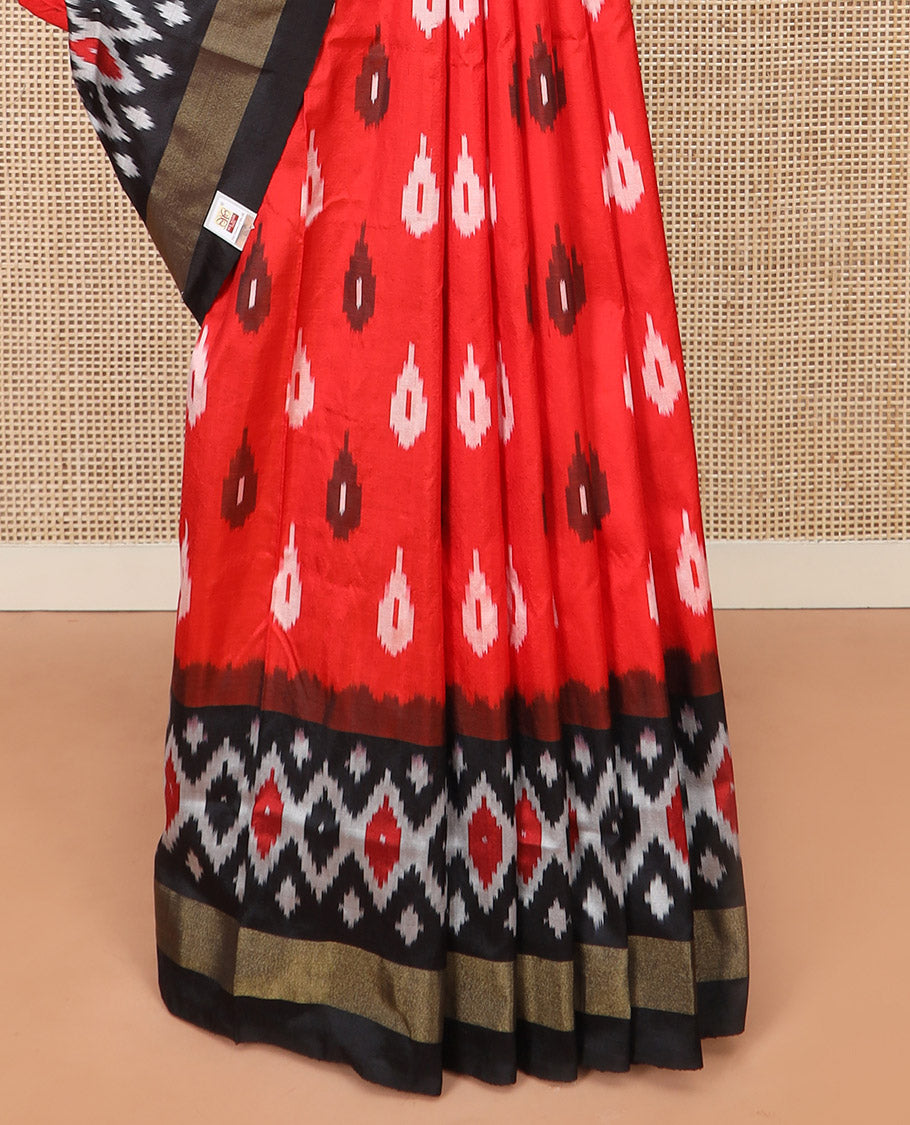 Red Ikkat Silk Saree Brightened with Ikkat Buttas, Complemented by a Contrast Ikkat Design Border, a Hazily Woven Pallu of Diamond Patterns, and a Contrast Blouse