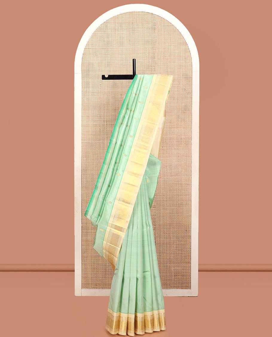 Green Kanchipuram Silk Saree, Featuring Zari Buttas, a Contrast One-Sided Border of Panner Sombu, Muthu, Banaras, and Jaal Design, Zari Design Pallu, and No Blouse