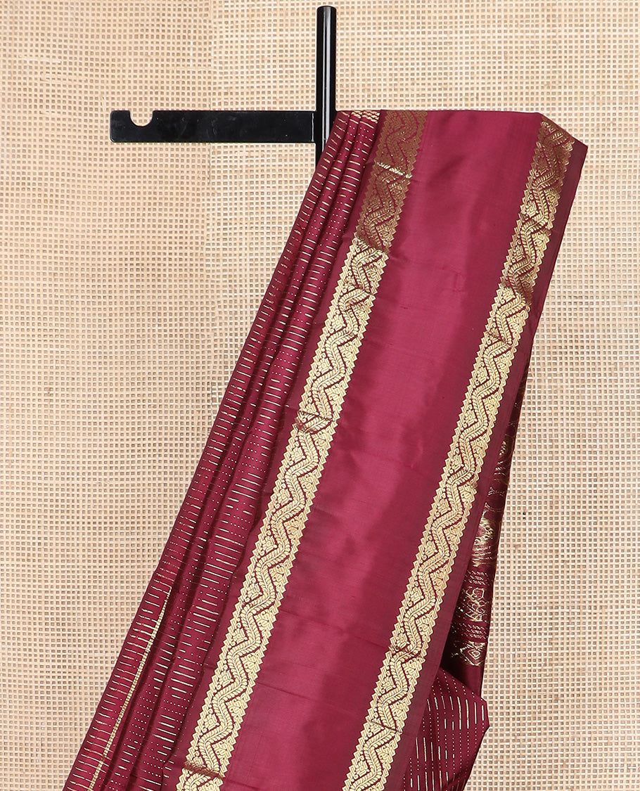 Maroon zari buttas Kanchipuram silk saree, one-sided rettai pettu zari border, and intricately designed pallu