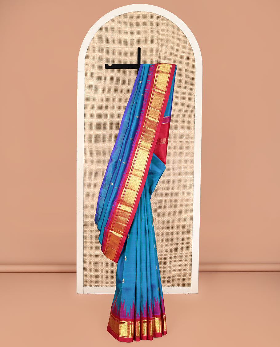 Blue Kanchipuram Silk Saree, Beautifully Bedecked with Zari Buttas, Complemented by Contrast One-Sided Border of Thazampoo Rekku, Thilakam Mokku, and Jaal Designs, Pallu of Zari Designs, and Comes Without a Blouse