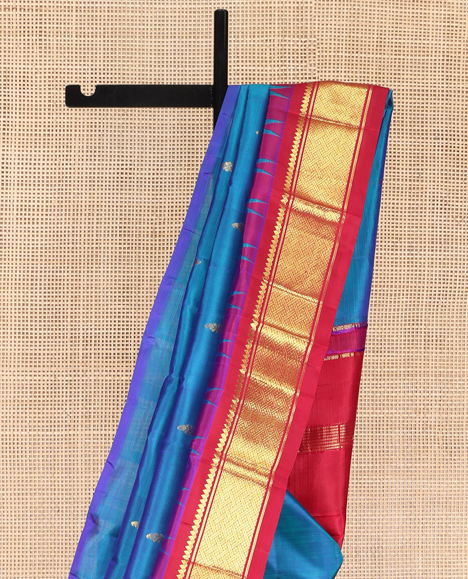 Blue Kanchipuram Silk Saree, Beautifully Bedecked with Zari Buttas, Complemented by Contrast One-Sided Border of Thazampoo Rekku, Thilakam Mokku, and Jaal Designs, Pallu of Zari Designs, and Comes Without a Blouse