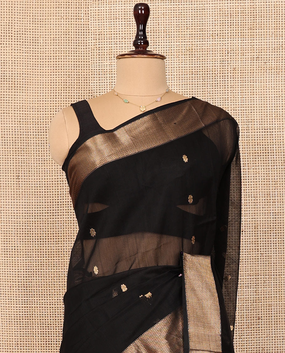 Black Maheshwari Cotton Saree, Spotlighted by Buttas All Over Its Body, Highlighted by a Traditional Zari Border of Chevron Stripes, Pallu of Chevron Stripes, and Paired with a Matching Blouse