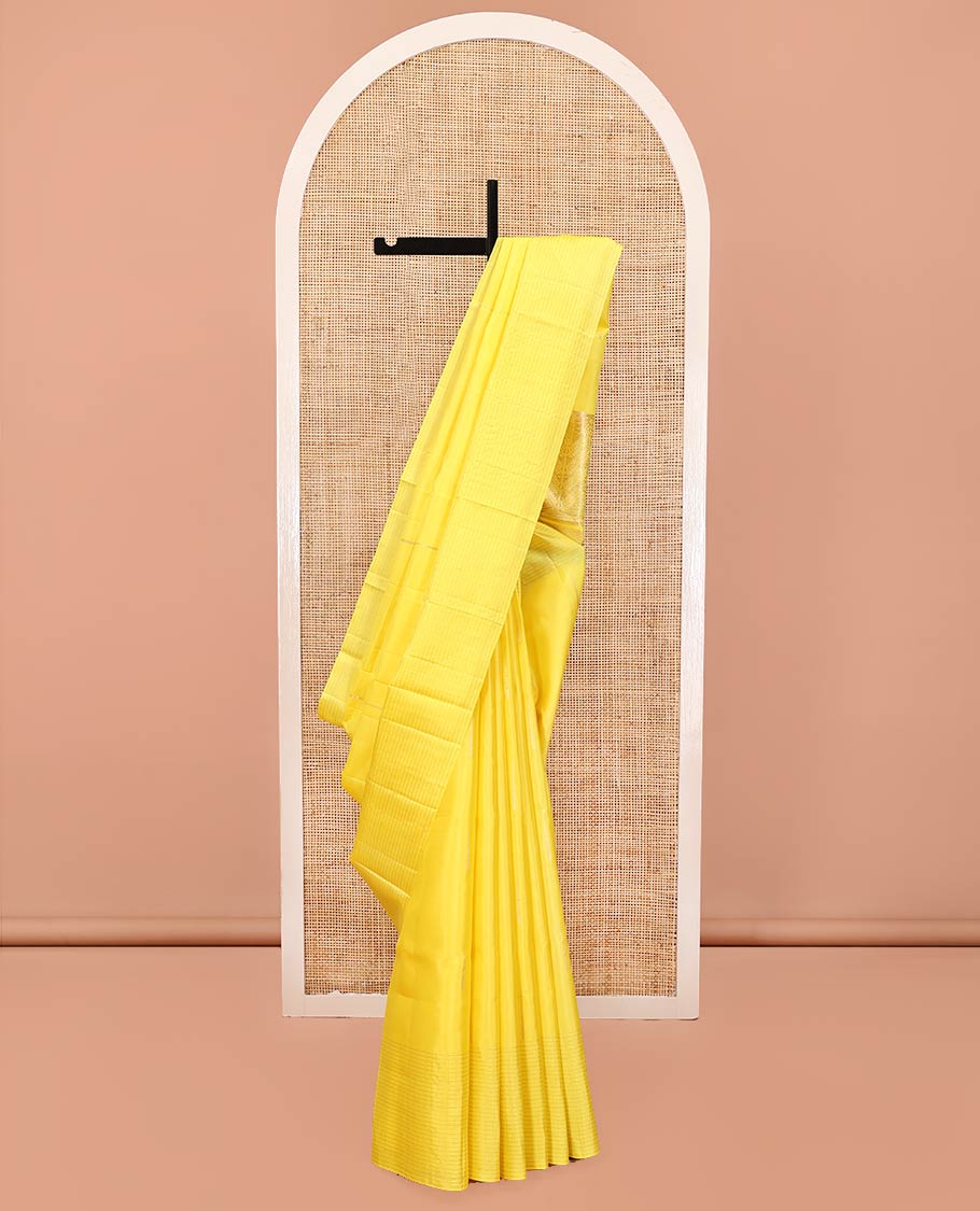 Yellow Mayuri Soft Silk Saree, Sparsely Sparkled with Malli Mokku Buttas All Over Its Body, Highlighted by Zari Striped Border, Pallu of Intricate Designs, and Paired with a Matching Blouse