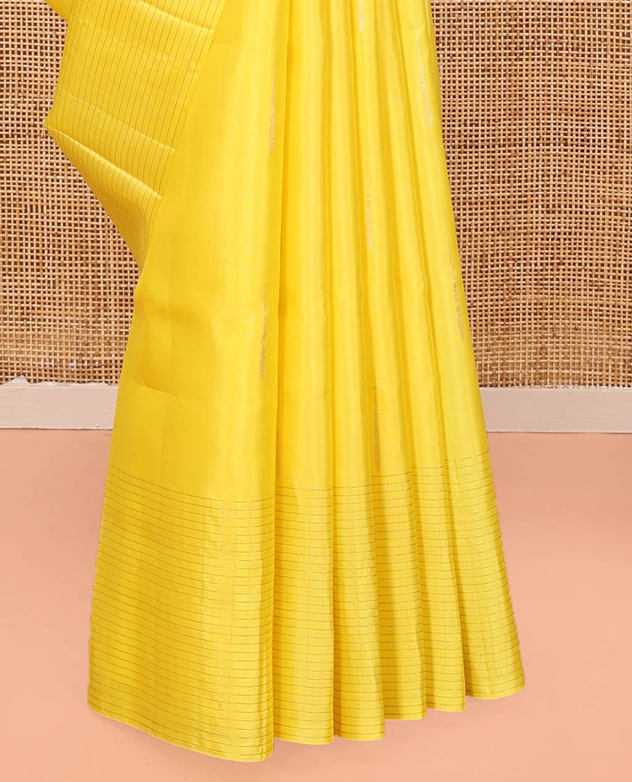 Yellow Mayuri Soft Silk Saree, Sparsely Sparkled with Malli Mokku Buttas All Over Its Body, Highlighted by Zari Striped Border, Pallu of Intricate Designs, and Paired with a Matching Blouse