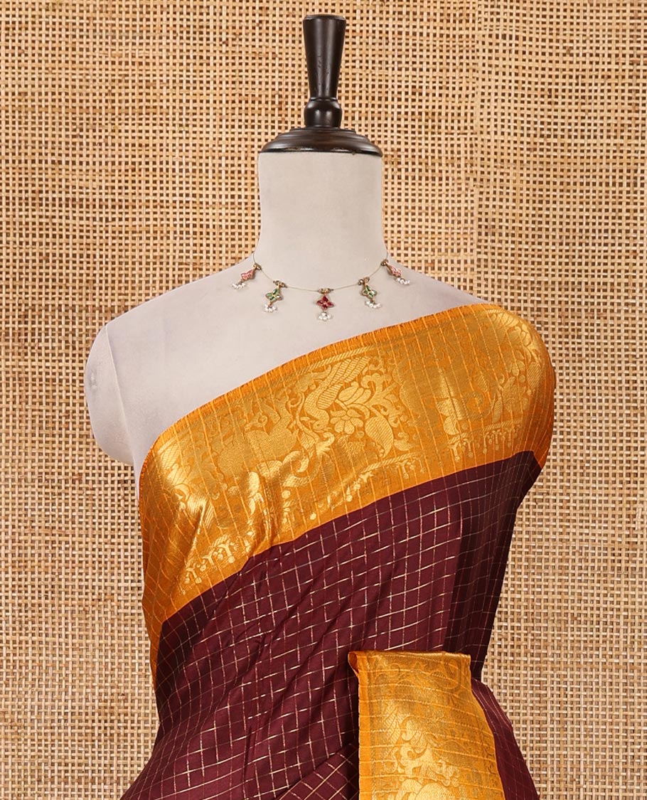 Maroon zari checked semi-taffeta silk saree, contrast deer motifs zari woven border, striped pallu & contrast striped zari border blouse