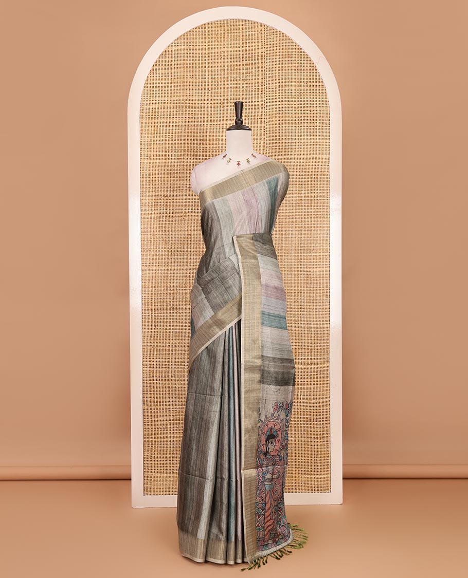 Green vertical stripes printed hand-brush dyed Katan silk saree, gold zari bavanji border, Madhubani-style human figurines printed pallu, and floral printed blouse