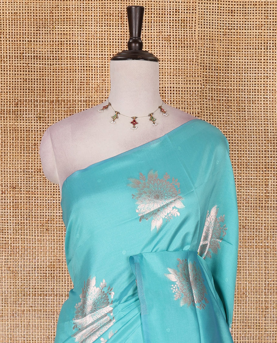 Borderless green floral motifs steeped elite soft silk saree, contrast lotus-like motifs pallu, and contrast buttas blouse