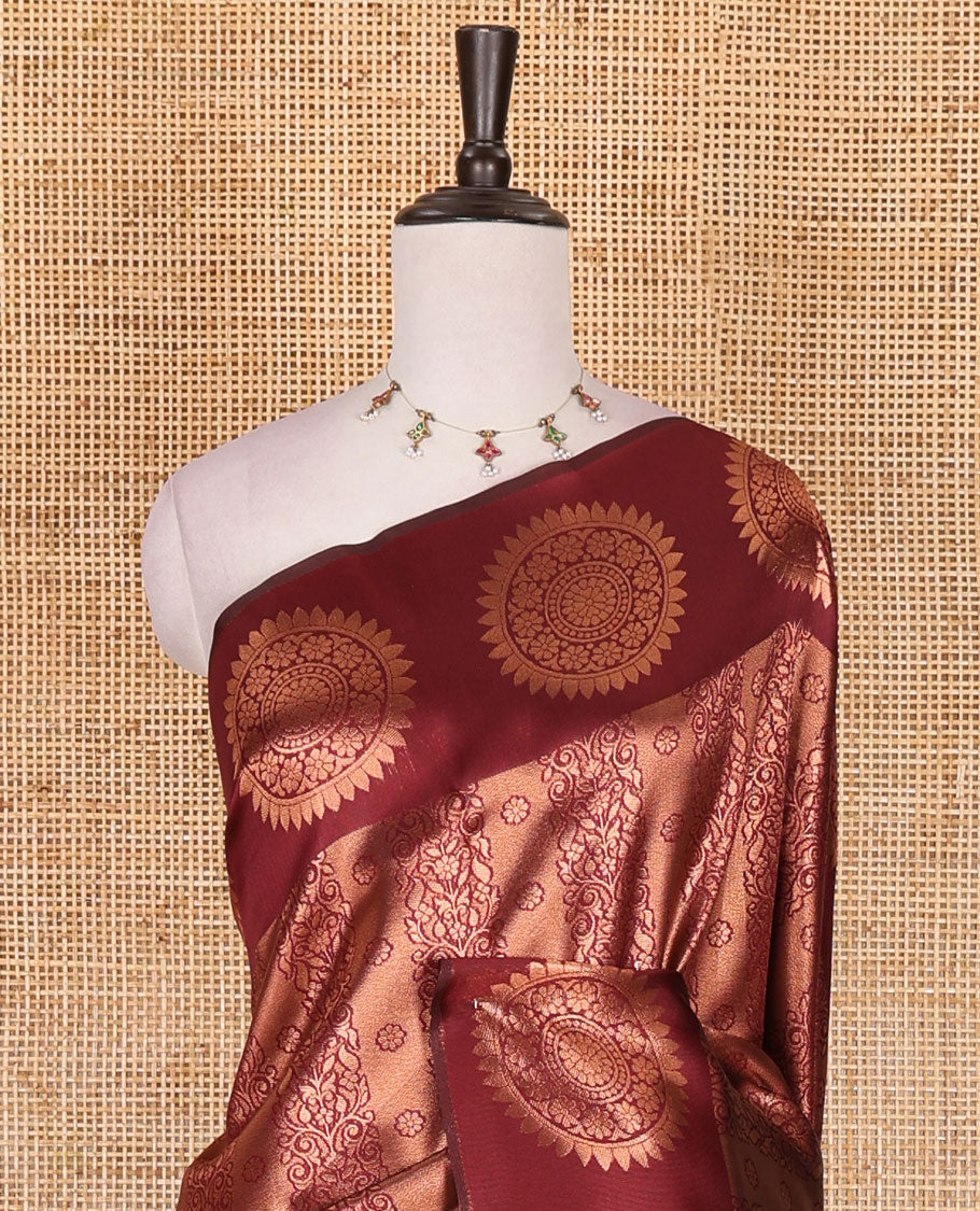 Maroon jacquard kanchi tissue saree, zari chakram motifs border, intricately zari woven pallu, and a matching zari design blouse