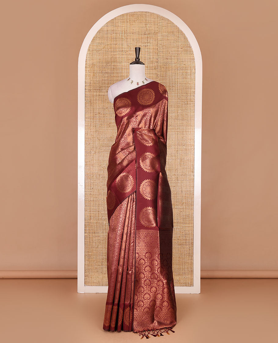 Maroon jacquard kanchi tissue saree, zari chakram motifs border, intricately zari woven pallu, and a matching zari design blouse