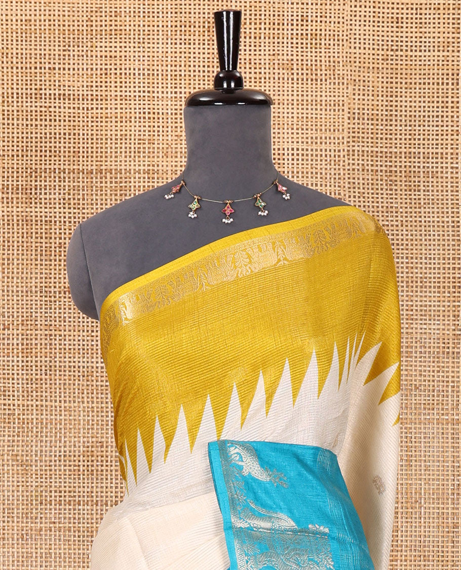 Half-white zari stripes and buttas dola silk saree, contrast yellow-blue Ganga-Jamuna temple elephant motifs border, paisleys printed pallu, and contrast elephant buttas blouse