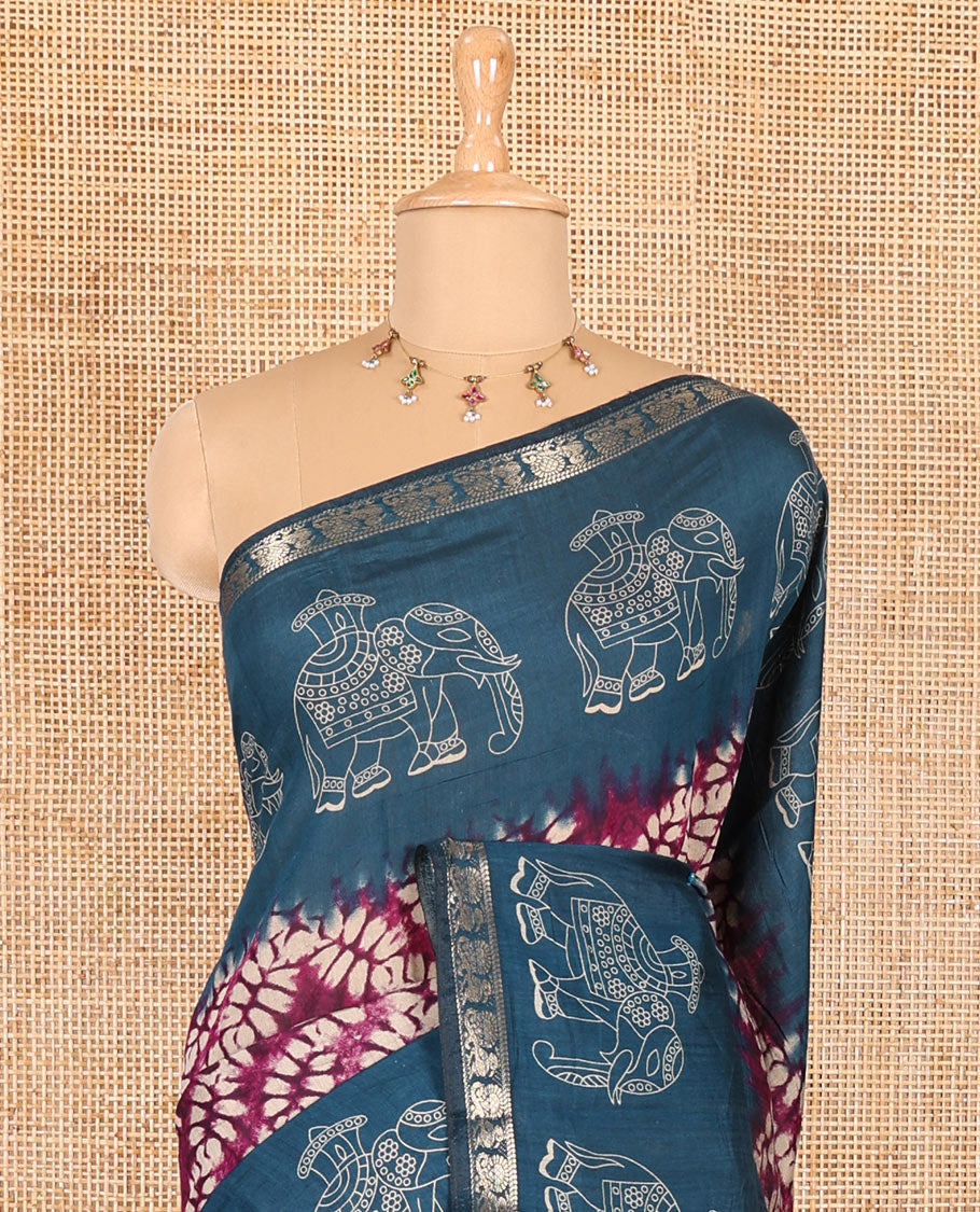 Purple shibori printed muslin cotton saree, contrast zari border of elephant motifs print, big elephant printed pallu, and a contrast printed blouse