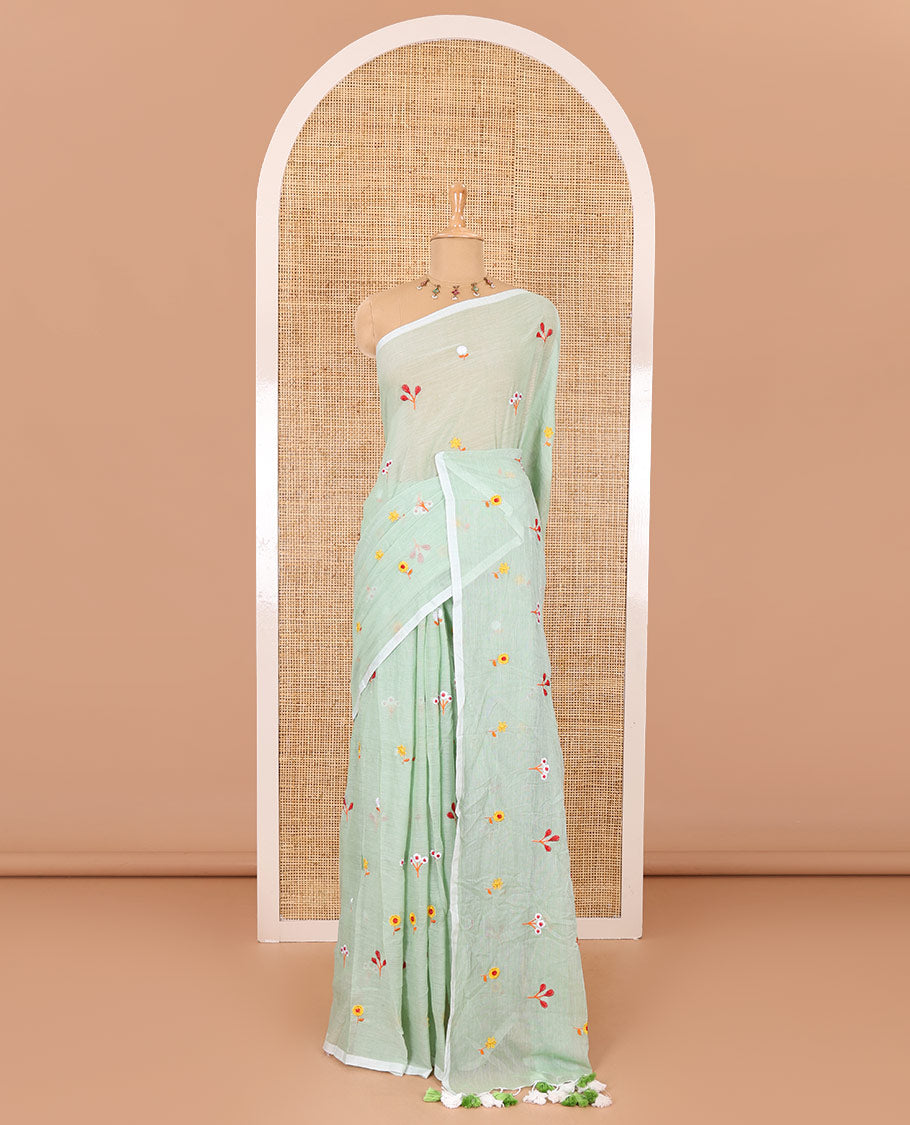 Borderless pista green floral motifs thread embroidered khadi mul cotton saree, floral motifs thread embroidered pallu, and a matching plain blouse