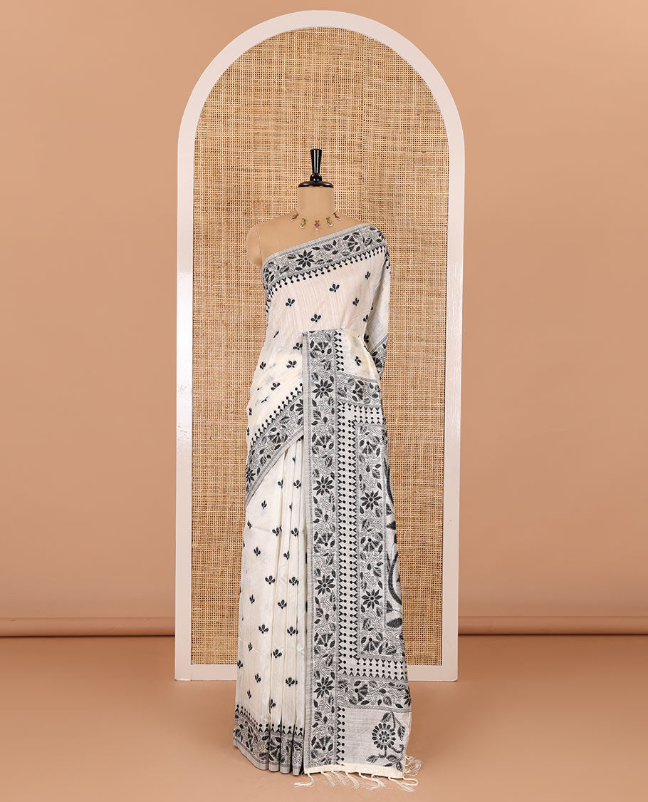 Half-white and black floral thread buttas woven jute cotton saree, floral thread weave border, floral-paisley weave pallu, and a matching blouse