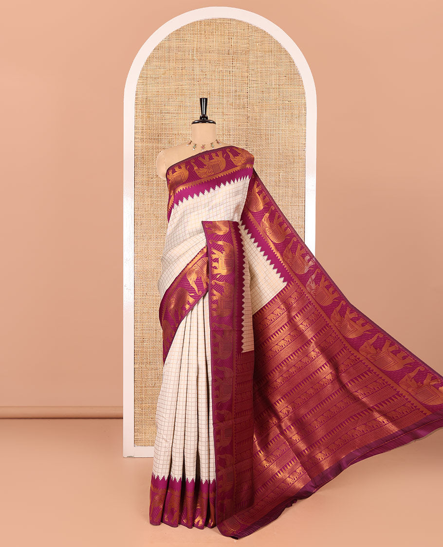 Beige checked design litchi saree, contrast temple elephant motifs border, geometric patterned pallu, and a contrast jacquard blouse