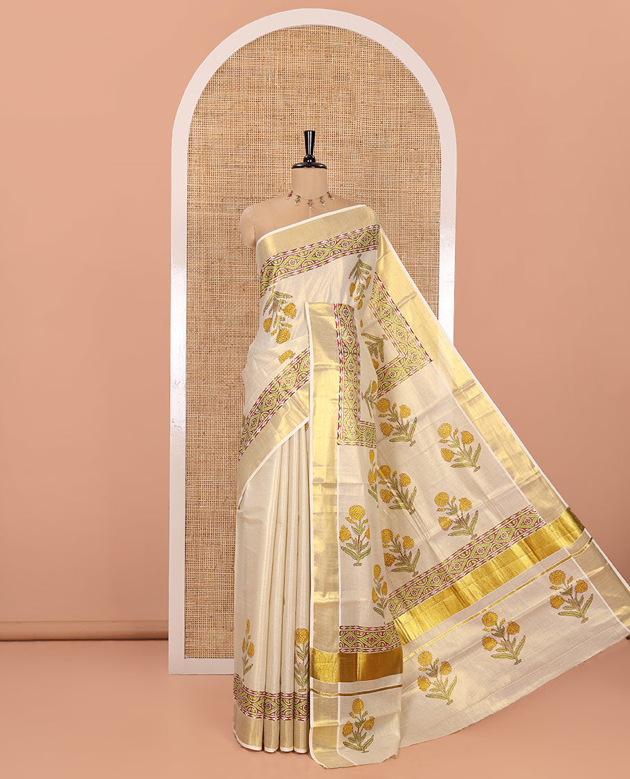 Gleaming Cream Kerala Tissue Saree, Enthralled with Floral Buttas Printed on Its Body, Highlighted by Golden Zari Border, Pallu Adorned with Floral Print, and Paired with a Printed Blouse