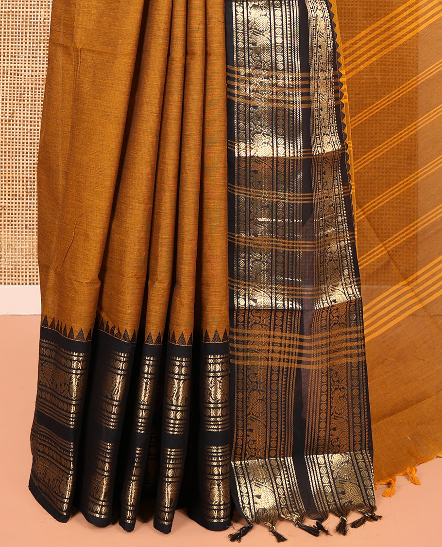 Mustard Plain Chettinad Cotton Saree, Complemented by a Contrast Rettai Pettu Temple Sliver-Sheen-Gold Zari Border of Coin, Elephant, and Peacock Designs, Subtly Striped Pallu, and Paired with a Matching Blouse