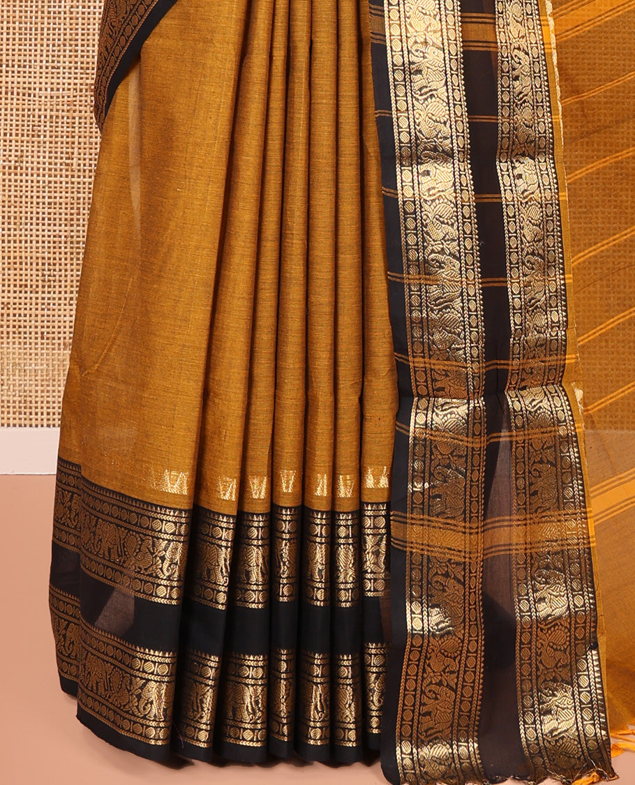 Mustard Plain Chettinad Cotton Saree, Complemented by a Contrast Rettai Pettu Lite-Gold-Zari Border of Temple, Coin, Elephant, and Peacock Designs, Subtly Striped Pallu, and Paired with a Matching Blouse