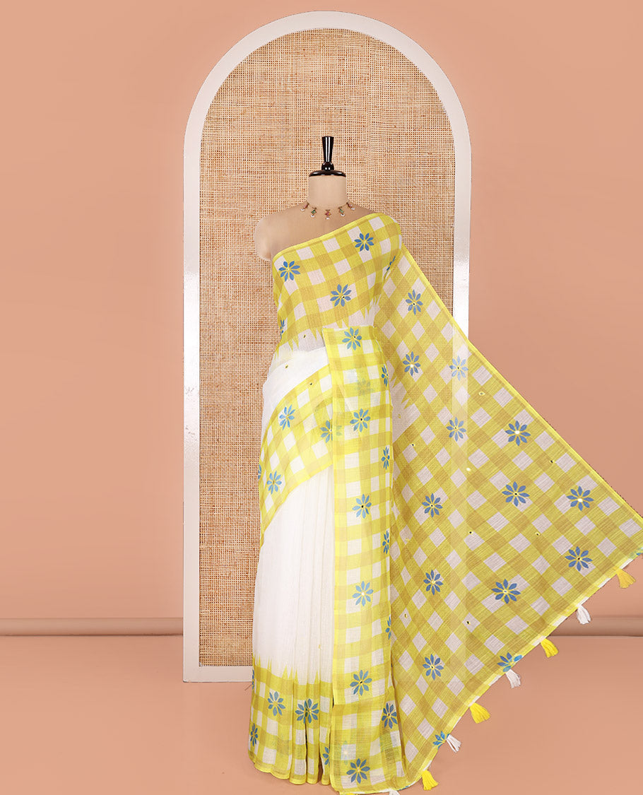White and Green Linen Cotton Saree, Adorned with Mirror Work On Its Body, Complemented by Contrast Temple Checked Border of Floral Print and Mirror Work, Pallu Mirrors the Same Design and Paired with a Contrast Blouse