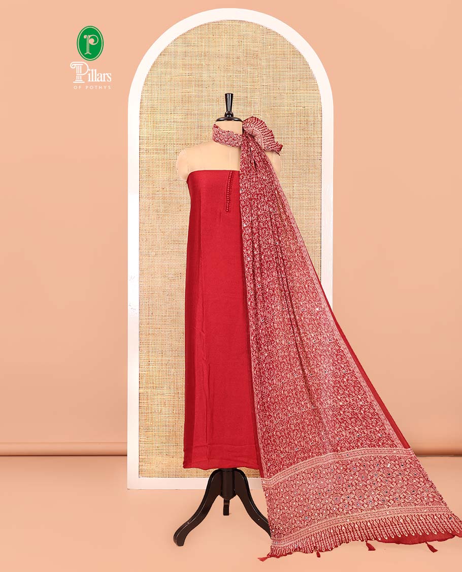 Red Material Chudidar Set, Subtly Woven with Pom-Pom Potli Neck Vichitra Silk Top, a Plain Santoon Bottom, Paired with Crushed Georgette Dupatta of Ajrakh Print and Mirror Work