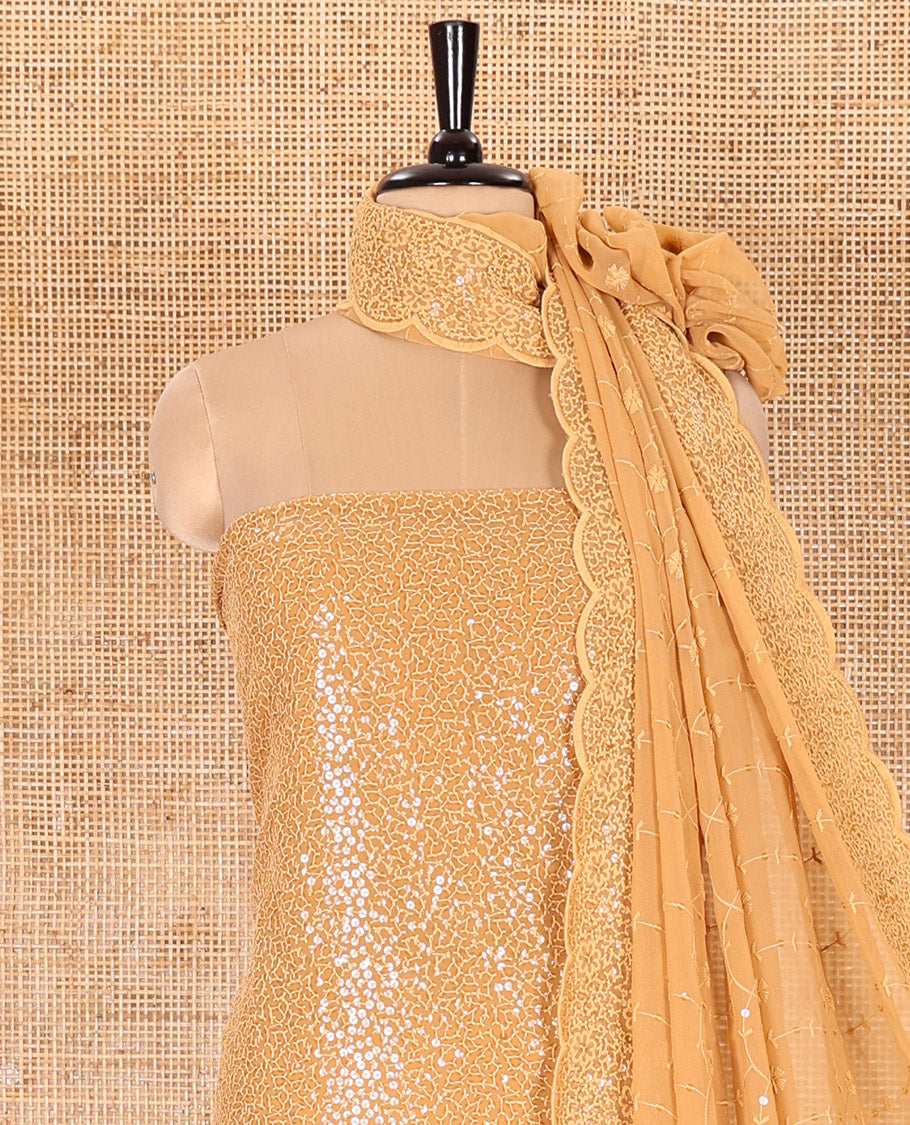 Golden Material Chudidar Set Features Sequin Embroidered Georgette Top, a Plain American Crepe Bottom, and a Scallop Dupatta Embellished with Floral Vine Embroidery