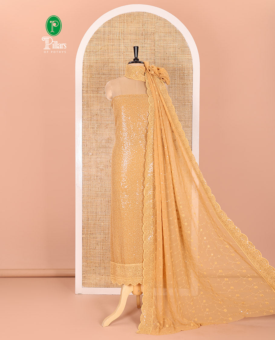 Golden Material Chudidar Set Features Sequin Embroidered Georgette Top, a Plain American Crepe Bottom, and a Scallop Dupatta Embellished with Floral Vine Embroidery