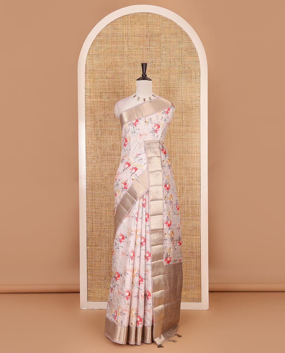 Light peach floral motifs printed fancy tussar saree, ogee patterned zari border, plain pallu, and plain matching blouse