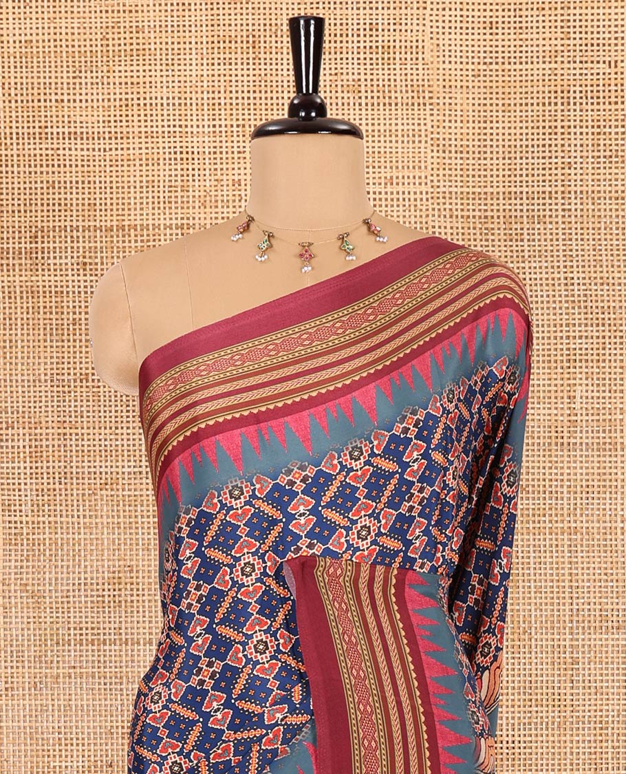 Blue patola style geometric printed Italian Crepe saree, contrast temple ikkat printed border, Kalamkari printed pallu, and a printed bordered blouse