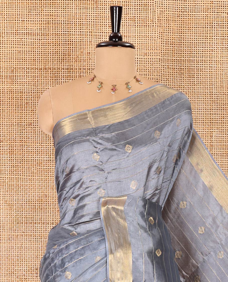 Grey zari buttas and striped banana pith saree, bavanji border, zari striped pallu, and a matching blouse