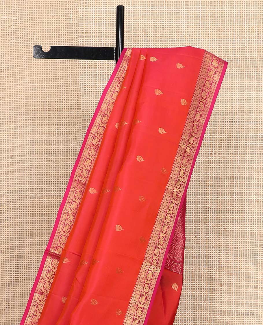 Orange floral buttas Vasundhara silk mix saree, contrast border of thilakam, muthu, cross kamalam, and kodi visiry designs, and ogee patterned pallu