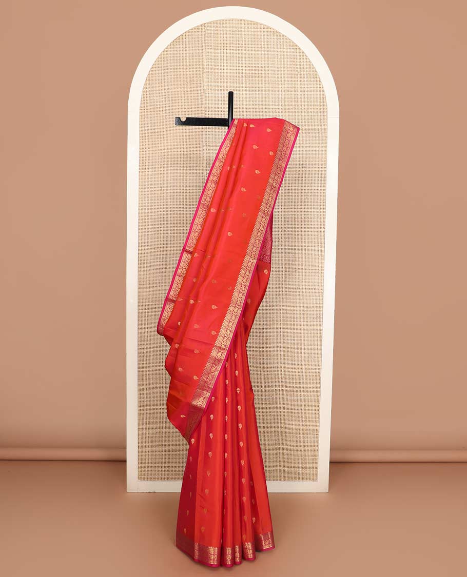 Orange floral buttas Vasundhara silk mix saree, contrast border of thilakam, muthu, cross kamalam, and kodi visiry designs, and ogee patterned pallu