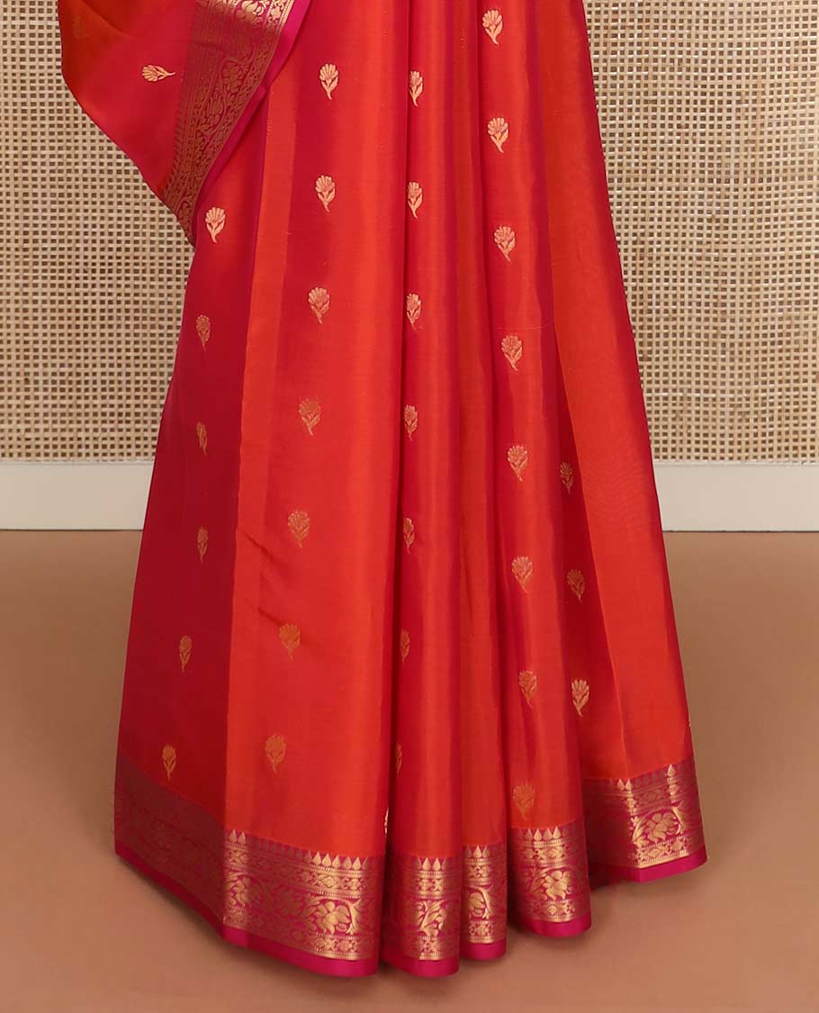 Orange floral buttas Vasundhara silk mix saree, contrast border of thilakam, muthu, cross kamalam, and kodi visiry designs, and ogee patterned pallu