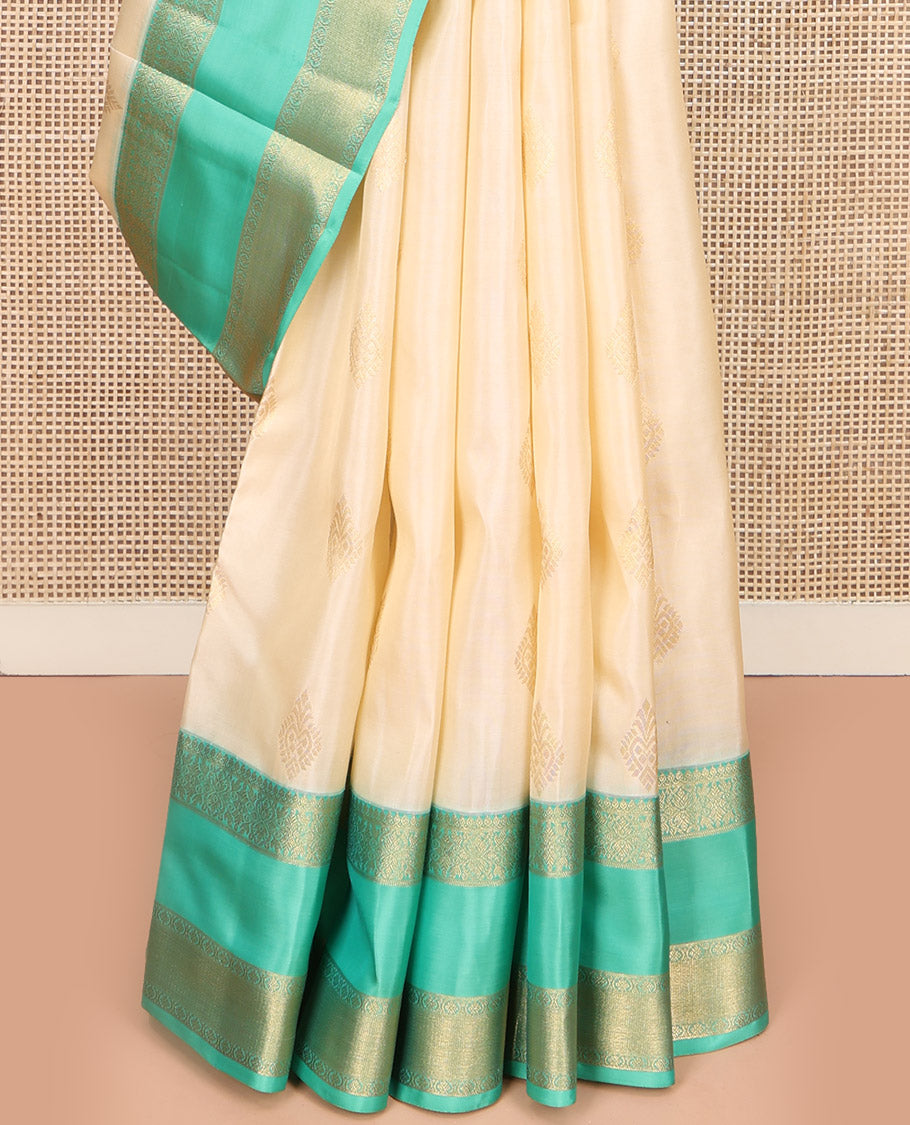 Cream Vasundhara Lite Silk Mix Saree, Gracefully Embellished with Zari Buttas All Over Its Body, Complemented by a Contrast Rettai Pettu Border of Thilakam Mokku, Kodi Visiry, and Kamalam Designs, Grand Jaal Design Pallu, and Paired with a Contrast Blouse