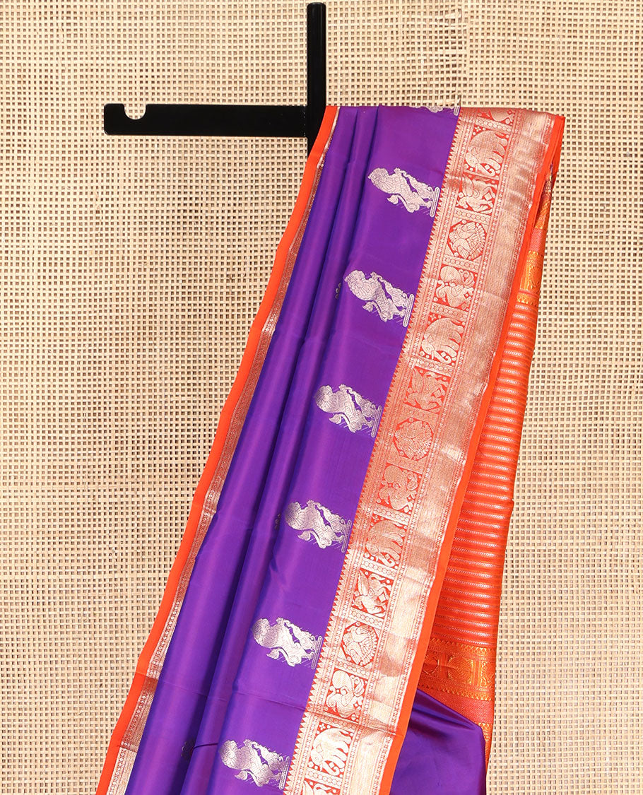 Purple Vasundhara Silk Saree, Embellished with Meena Buttas and Singam Buttas All Over Its Body, Complemented by Contrast Border of Rekku, Banaras, Yaanai, Mayil, and Vanki Designs, Pallu of Muthu Designs, and Paired with a Contrast Blouse