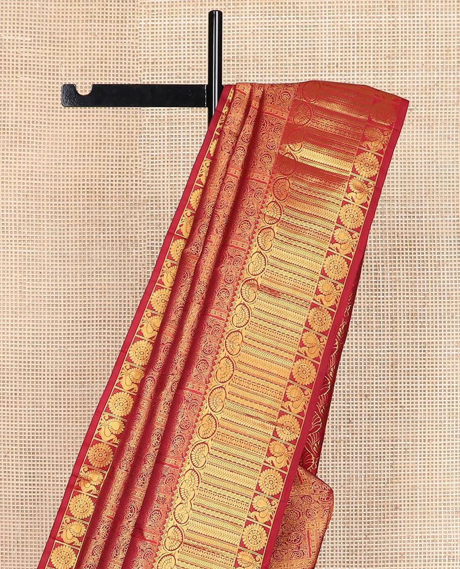 Light maroon jacquard Kanchipuram wedding silk saree, zari border of dhavana kodi, kathir, and mayil chakram, and ogee patterned pallu
