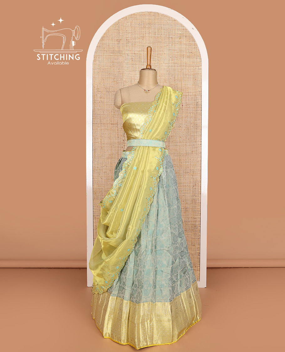 Pastel green art silk half-saree, floral vine with contrast traditional border skirt, brocade blouse, scallop embroidered dhavani, and detachable belt