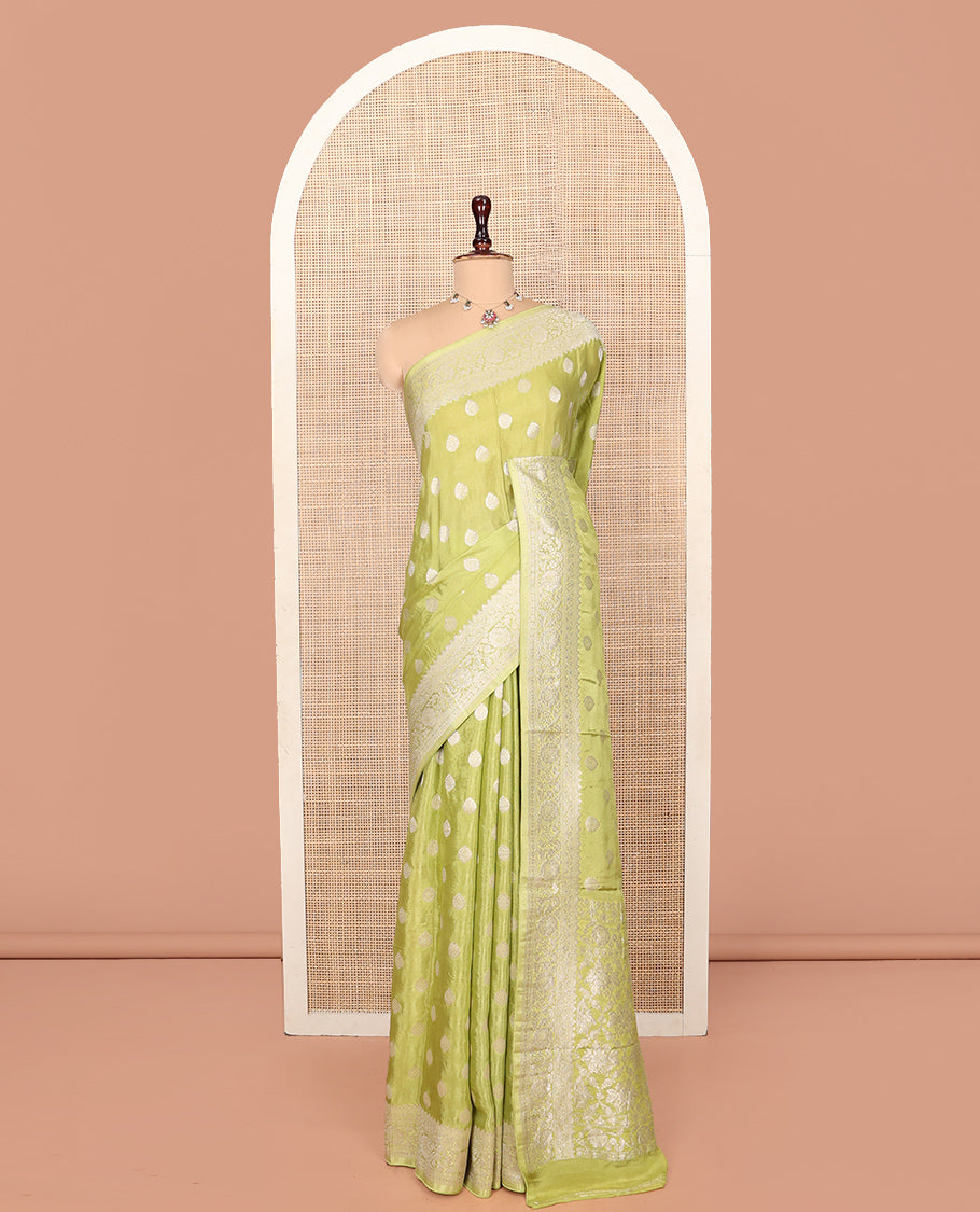 Green Fancy Crepe Saree, Gleamed Up with Thilakam Buttas, Highlighted by a Traditional Border, Intricately Designed Pallu, and a Matching Blouse