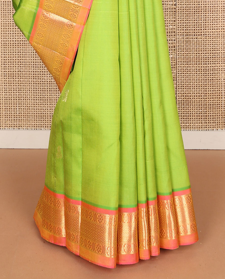 Green mayil buttas and zari stripes Kanchipuram silk saree, contrast one-sided border of laddu kamalam, and mayil kann designs, and zari design pallu