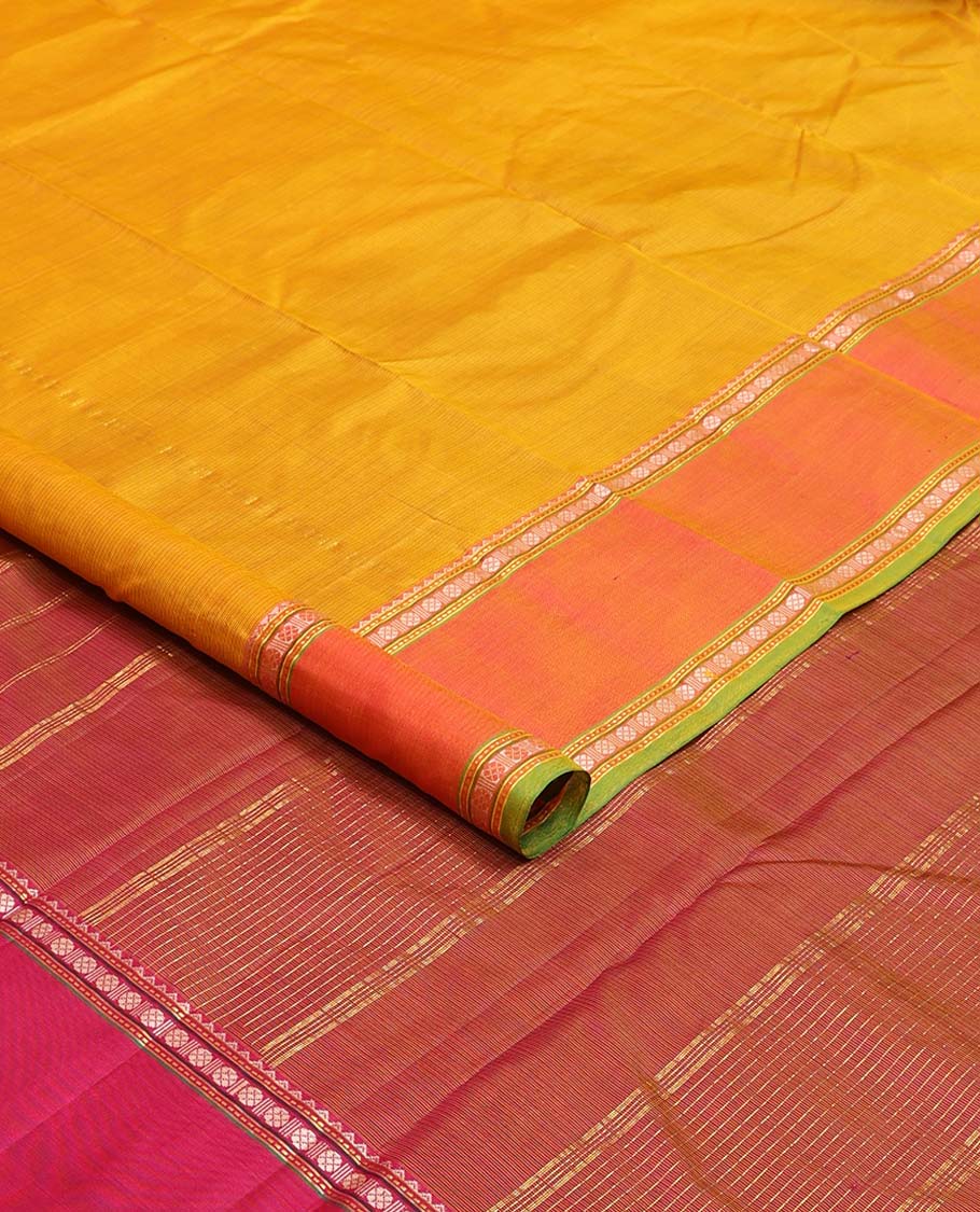 Yellow plain Kanchipuram silk saree, contrast border of rekku, muthu, rudraksham, and mayil designs, and zari striped pallu