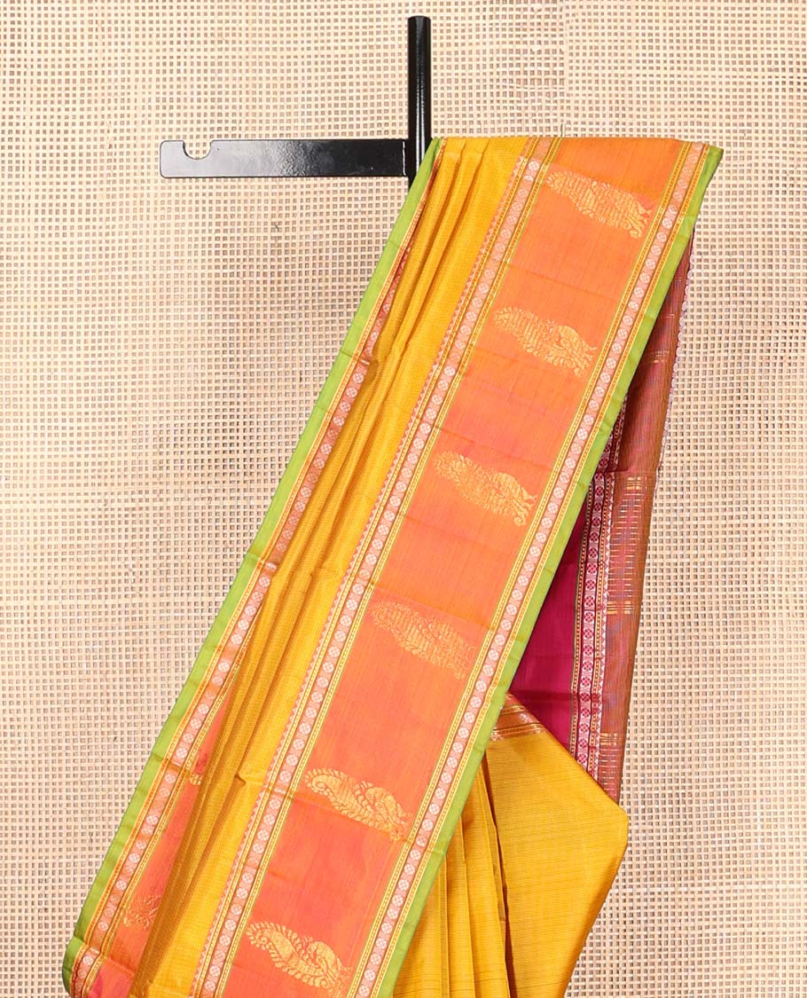 Yellow plain Kanchipuram silk saree, contrast border of rekku, muthu, rudraksham, and mayil designs, and zari striped pallu