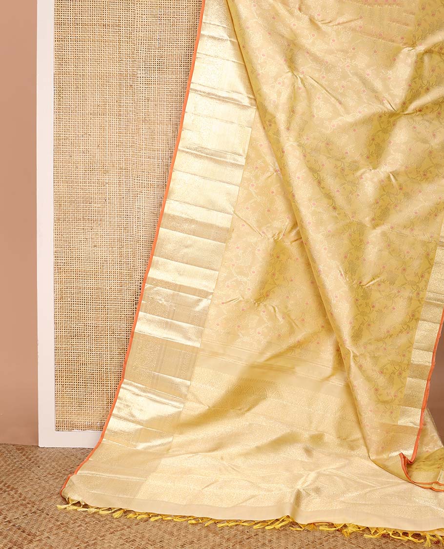 Yellow jacquard Kanchipuram silk saree, zari border of thilakam, kuyil kann, and arumbu manga designs, and geometric patterned pallu