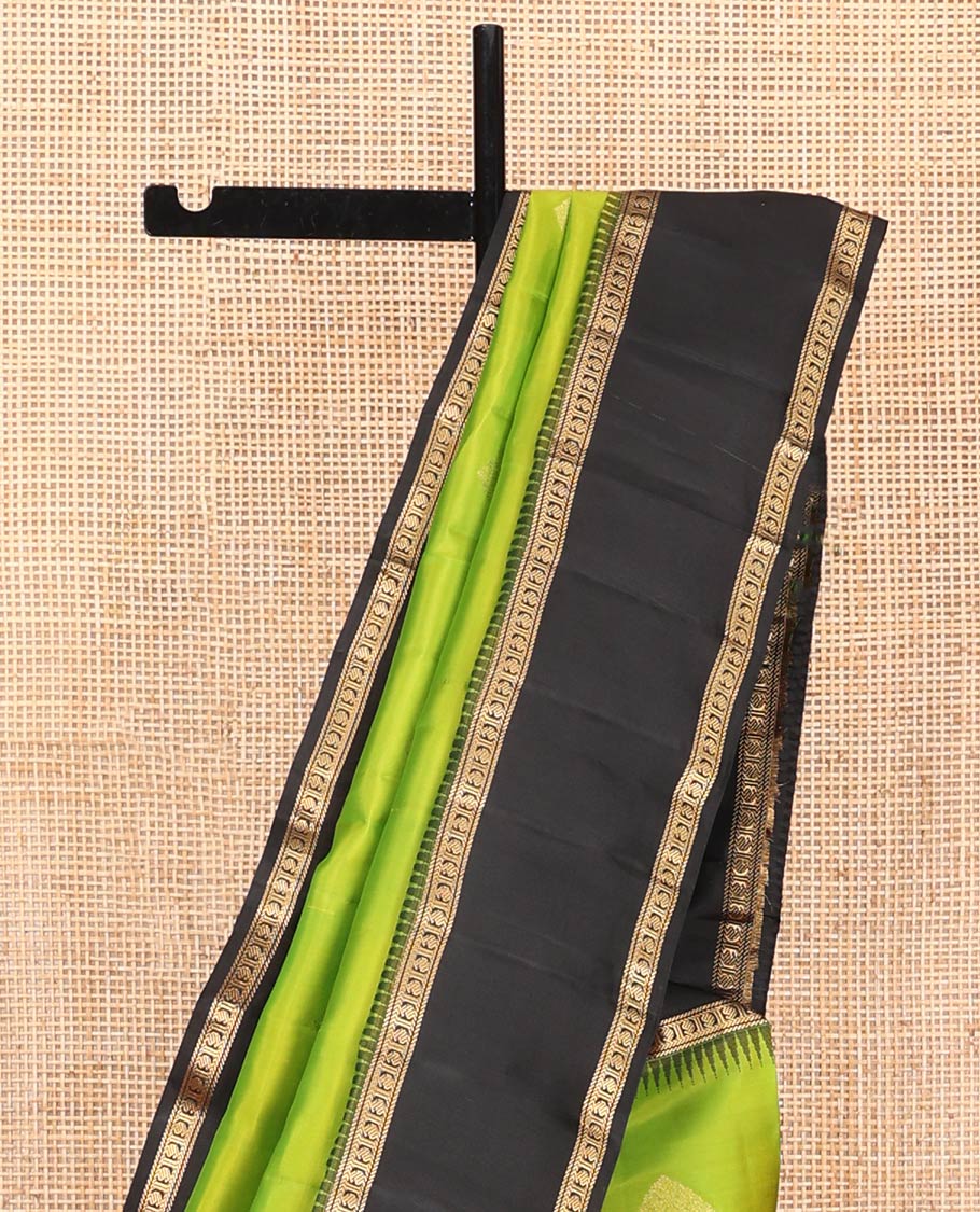 Green Vasundhara Silk Saree, Detailed with Zari Buttas on Its Body, Complemented by Contrast Temple Border of Banaras, Kathir, and Manga Designs, Grandly Woven Jaal Pallu, and Paired with a Contrast Blouse