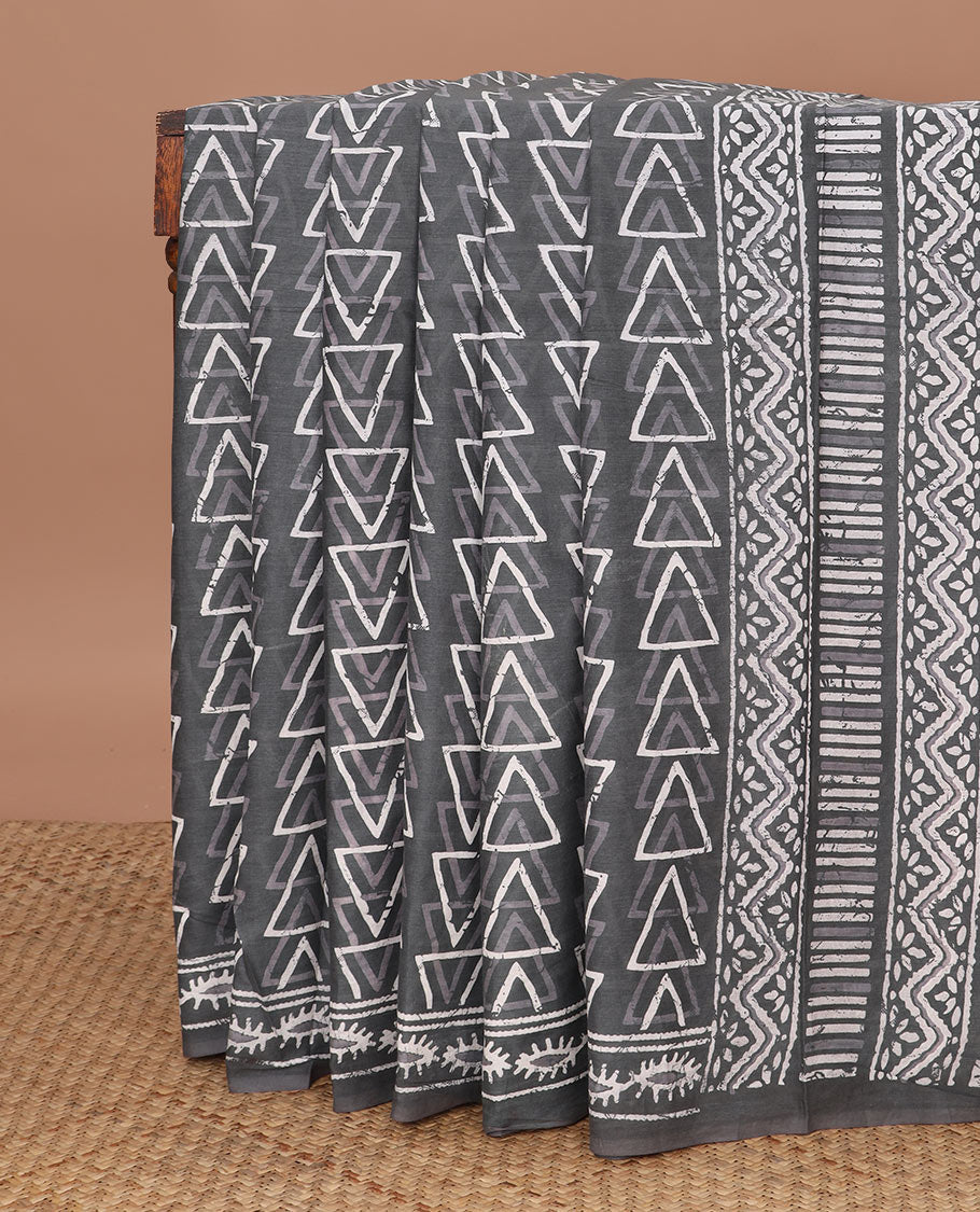 Grey batik-style triangle motifs mul mul cotton saree, batik-style printed border & floral-geometric printed pallu