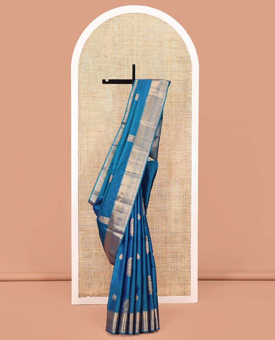 Blue Vasundhara Lite Silk Saree, Accentuated with Zari Buttas All Over Its Body, Highlighted by Zari Border of Thilakam, Mayil Kann, Kamalam, Rettai Neli, Yannai, and Vanki Designs, Delicately Woven Pallu and Paired with a Matching Blouse