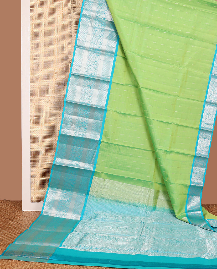 Parrot green muniya buttas Vasundhara silk mix, contrast border, and pallu of geometric zari designs