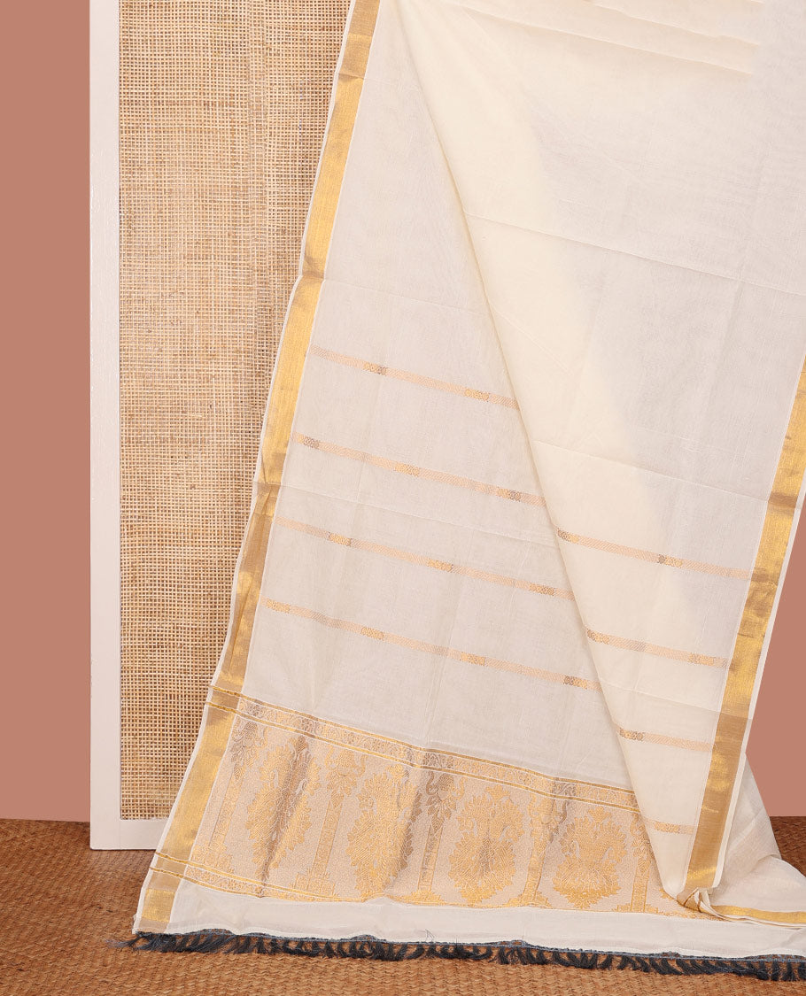 Cream Kerala Cotton Saree Elegantly Highlighted with Zari Stripes All Over Its Body, Bavanji Border, Pallu of Intricate Designs, and Paired with a Matching Blouse