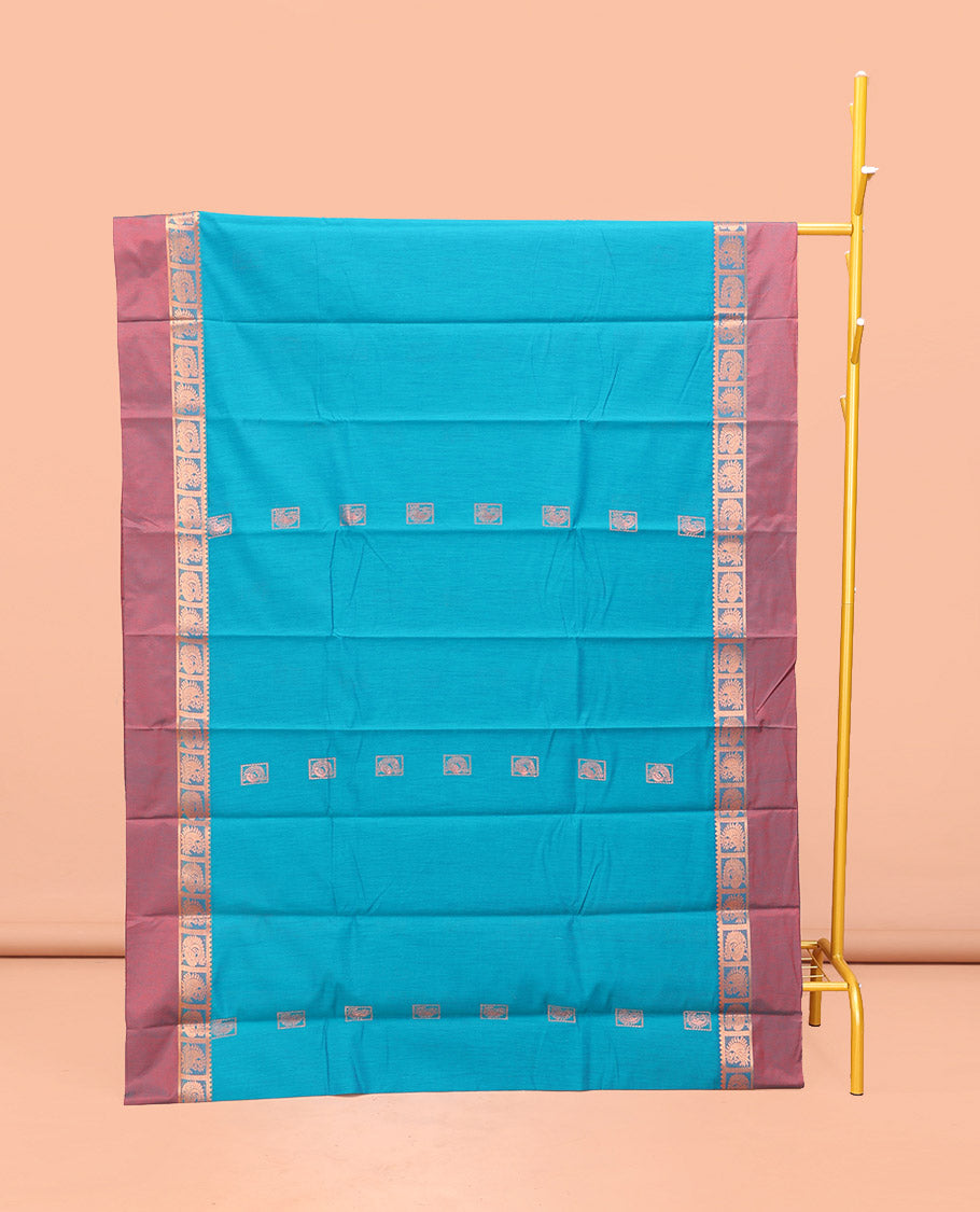 Blue Semi-Silk Cotton Saree, Decked Up with Zari Buttas All Over Its Body, Complemented by a Contrast Kal Eragina Border of Peacock Designs, Pallu Steeped with Elephant Zari Motifs, and Paired with a Matching Blouse